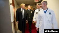 President Donald J. Trump talks with, from left to right, with Capt. Mark Kobelja, director of Walter Reed National Military Medical Center; Dr. Ronny Jackson, physician to the president; and Dr. James Jones, physician to the president and medical director of the Medical Evaluation and Treatment Unit, Jan. 12, 2018, in Bethesda, Md., following the president’s annual physical at the medical facility. 