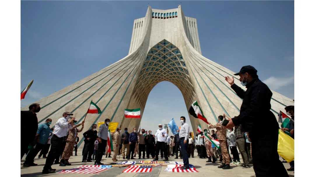Warga Iran menginjak bendera AS dalam aksi unjuk rasa di alun-alun Azadi (Kebebasan) ibu kota Teheran, menandai hari al-Quds (Yerusalem), 7 Mei 2021.
