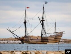 FILE - In this Dec. 12, 2014 file photo, the Mayflower II, a replica of the original ship that brought Pilgrims to Massachusetts in 1620, passes a jetty as it is towed out of Plymouth Harbor in Plymouth, Mass.