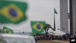 Uber drivers gather outside the Brazilian Congress to protest a bill aimed at regulating ride-sharing apps, Oct. 31, 2017, in Brasilia, Brazil.