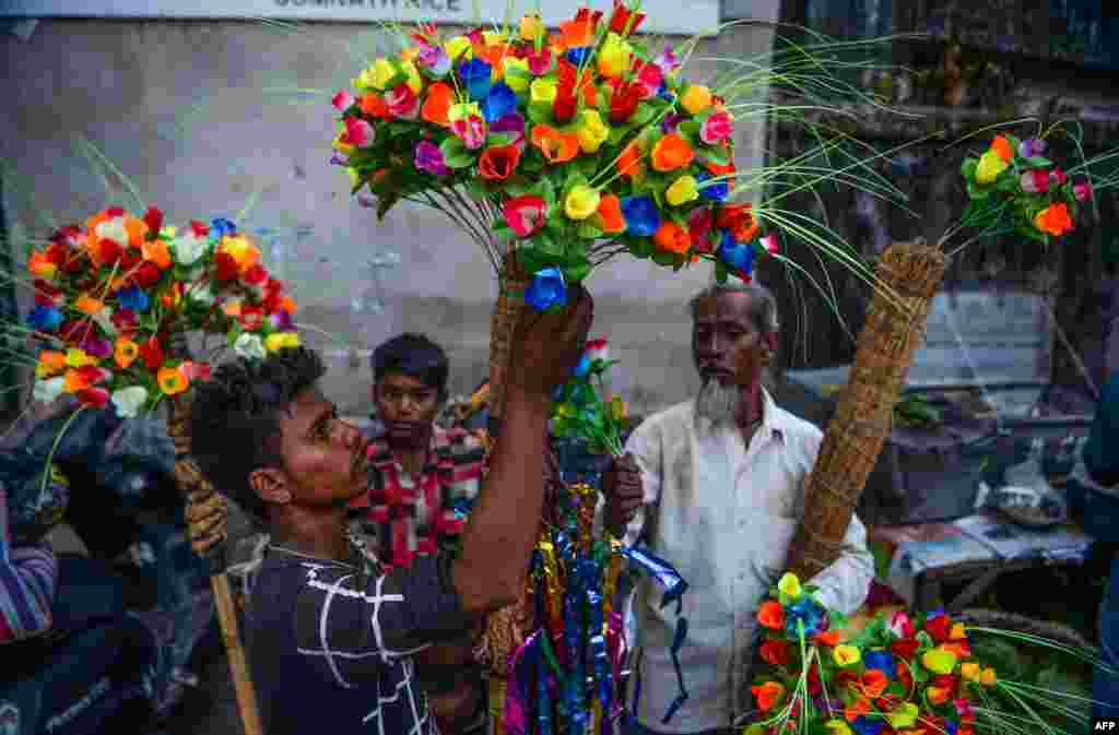 Vendors sell artificial flowers at a roadside market on the eve of the Chhath Puja Festival in Siliguri, India.