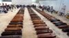Cercueils des victimes du naufrage de Lampedusa dans un hangar de l'aéroport de l'île italienne le 5 octobre 2013.