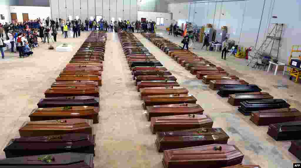 Coffin of victims are seen in an hangar of Lampedusa airport, Oct. 5, 2013, after a boat with migrants sank killing more than 100 people. Italian emergency services hoped to resume the search for bodies despite rough seas after the accident, in which 111 African asylum-seekers are confirmed dead and around 200 more are still missing.