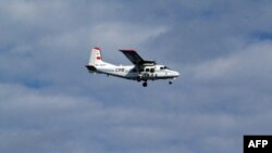 Handout picture taken by Japan Coast Guard shows a Chinese state-owned plane flying in airspace over the disputed island, called the Senkakus in Japanese and Diaoyus in Chinese, in the East China Sea, December 13, 2012