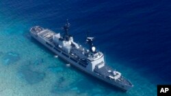 FILE - In photo provided by the Armed Forces of the Philippines, Aug. 29, 2018, shows the Philippine Navy ship BRP Gregorio del Pilar after it ran aground during a routine patrol in the vicinity of Half Moon Shoal, which is called Hasa Hasa in the Philippines, off the disputed Spratlys Group of islands in the South China Sea.