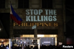 People take part in a protest against the government of Philippine President Rodrigo Duterte in front of the Philippine consulate in New York, Dec. 10, 2017.