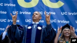 President Barack Obama and student Jacqueline Rodriguez flash the symbol of the school mascot "Anteaters" of the University of California, Irvine, in Anaheim, June 14, 2014.