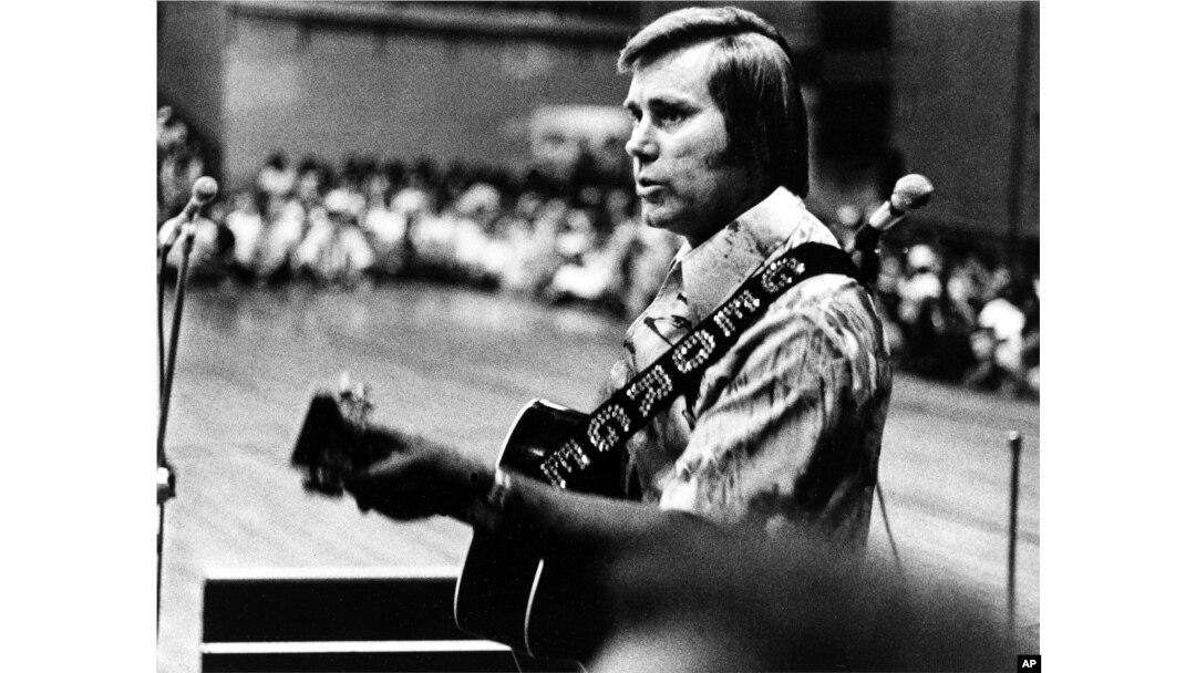 FILE - In this undated photo, Country singer George Jones is shown performing with his guitar.