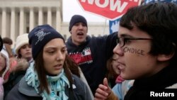 FILE - A pro-choice supporter is confronted by pro-life supporters at a rally in front of the U.S. Supreme Court in Washington January 22, 2007.