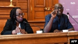 President of the Association for the Protection of Human Rights and Detained Persons Pierre Claver (R) and Burundian journalist Elyse Ngabire (L) speak during a press conference organized by the International Federation for Human Rights (FIDH) about a May 17 referendum in Burundi, in Paris, May 15, 2018.