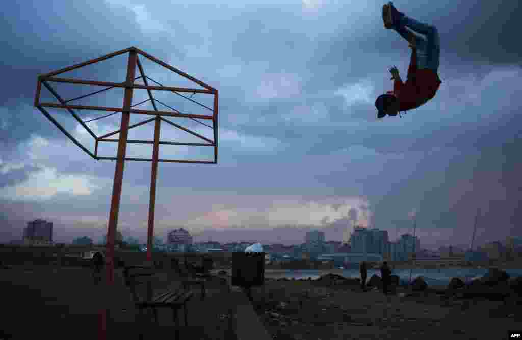 A Palestinian youth makes a jump near the beach in Gaza City.