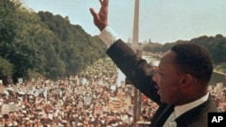 Martin Luther King Jr. acknowledges the crowd at the Lincoln Memorial for his "I Have a Dream" speech during the March on Washington, Aug. 28, 1963.
