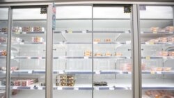 FILE - Empty shelves are seen in the meat aisle of Co-Op supermarket, Harpenden, Britain, Sept. 22, 2021.