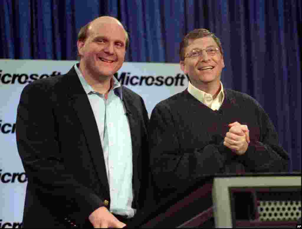 Microsoft's Steve Ballmer (L) and Bill Gates react to a question during a news conference, Jan. 13, 2000 in Redmond, Washington, where Gates announced that Ballmer will become the new chief executive officer.