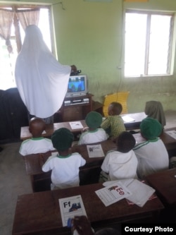 Students watch "Sesame Square" with their teacher in a school in Ijebu-Lekki, Nigeria, February 2012. Naomi Moland, a lecturer at American University in Washington who studies the Nigerian version of "Sesame Street," said the program producers tried to indirectly combat Boko Haram in northern Nigeria. (N. Moland)