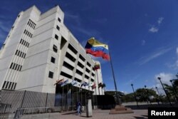 FILE - A man walks in front of a building of the Venezuela Supreme Court in Caracas, Dec. 23, 2015.