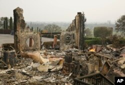 The remains of the Signorello Estate winery continue to smolder, Oct. 10, 2017, in Napa, California.