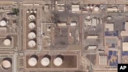 This satellite image provided Planet Labs PBC shows the aftermath of an attack claimed by Yemen's Houthi rebels on an Abu Dhabi National Oil Co. fuel depot in the Mussafah neighborhood of Abu Dhabi, United Arab Emirates, Jan. 22, 2022. 