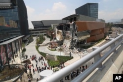 The Artz Pedregal shopping mall stands partially collapsed, on the south side of Mexico City, July 12, 2018.
