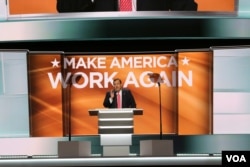 Chris Christie speaks as the theme of the second night at the Republican National Convention in Cleveland, Make America Work Again, is displayed in the background, July 19, 2016. (A. Shaker/VOA)