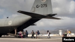 Evacuees leaving the destruction of Hurricane Irma board a C-130 Hercules transport aircraft of the Royal Netherlands Air Force at St. Martin airport September 10, 2017. (Netherlands Ministry of Defense via REUTERS) 