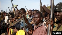 FILE - Jikany Nuer White Army fighters hold their weapons in Upper Nile State, February 2014.