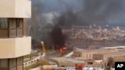 In this image made from video posted by a Libyan blogger, the Cortinthia Hotel is seen under attack in Tripoli, Libya, Tuesday, Jan. 27, 2015. 