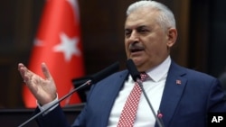 Binali Yildirim, who replaces the outgoing prime minister, Ahmet Davutoglu, addresses his lawmakers at the parliament in Ankara, Turkey, May 24, 2016.