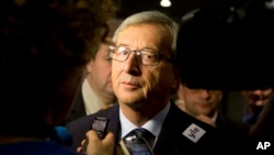 Leader of the Christian Democrat party Jean-Claude Juncker speaks with the media at his election headquarters in Luxembourg on Sunday, Oct. 20, 2013. 