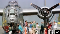 Spectators look at a B-24 Liberator, World War II bomber "The Dragon and His Tail" at the Knapp Airport in Berlin, Vermont. 