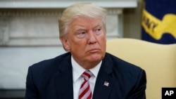 President Donald Trump talks to reporters during a meeting with Dr. Henry Kissinger, former Secretary of State and National Security Advisor under President Richard Nixon, in the Oval Office of the White House, May 10, 2017, in Washington.