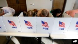 FILE - Every voting booth was filled by Madison County voters, November 6, 2018, as they filled out their paper ballots in Ridgeland, Mississippi.