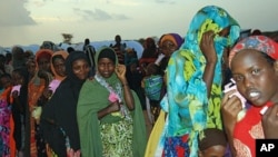 Women and Children holding their pink tickets queue for the evening meal at the Dollo Ado transit center in Ethiopia, October 26, 2011.