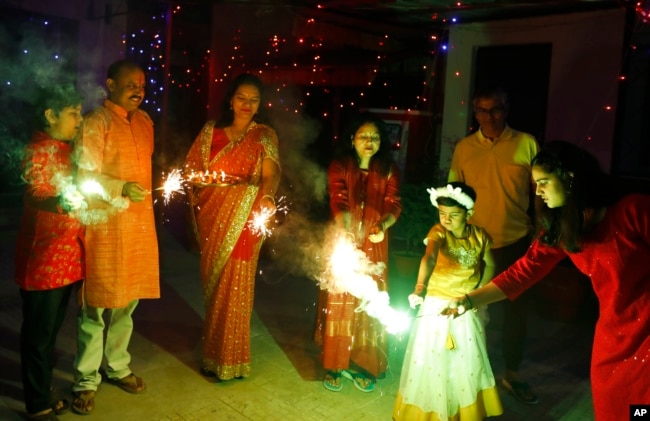 People play with firecrackers to celebrate during Diwali festival in Prayagraj, India, Thursday, Nov. 4, 2021. Diwali, the festival of lights, is one of Hinduism's most important festivals dedicated to the worship of Lakshmi, the Hindu goddess of wealth.