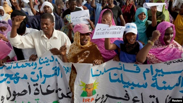 FILE - Mauritanian anti-slavery protesters march to demand the liberation of imprisoned abolitionist leader Biram Ould Abeid during a previous arrest.