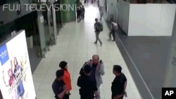 FILE - Kim Jong Nam, exiled half brother of North Korea's leader Kim Jong Un, gestures toward his face while talking to airport security and officials at Kuala Lumpur International Airport, Malaysia, in this image made Feb. 13, 2017, from Kuala Lumpur air