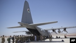 FILE - Afghan National Army soldiers line up to get into a C-130 Hercules at Kandahar Air Base in Kandahar, Afghanistan, Aug. 18, 2015. 