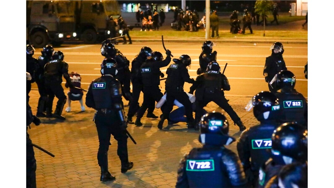 Police use truncheons on protesters during a mass protest following presidential election in Minsk, Belarus, Monday, Aug. 10, 2020.