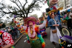 A member of the walking club Mondo Kayo revels as they march and dance down the route of the Krewe of Zulu parade on Mardi Gras day in New Orleans, Tuesday, Feb. 13, 2018.