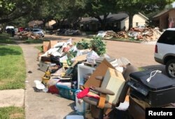 Damaged furniture, carpets and flooring are piled at the curbside by residents as many began repairs in the aftermath of Hurricane Harvey, in Houston, Texas, Sept. 2, 2017.