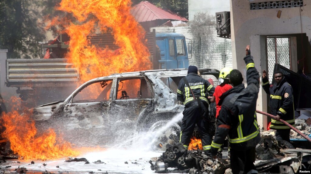 Somali firemen try to extinguish burning cars at the scene of a car bomb in Mogadishu, Somalia Jan. 29, 2019. In Somalia's northeastern mountains, al-Shabab and Islamic State are at war. 