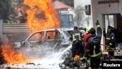 Somali firefighters try to extinguish flames at the scene of a car bomb in Mogadishu, Jan. 29. Al-Shabab and the Islamic State are battling in the country's mountainous northeast. 