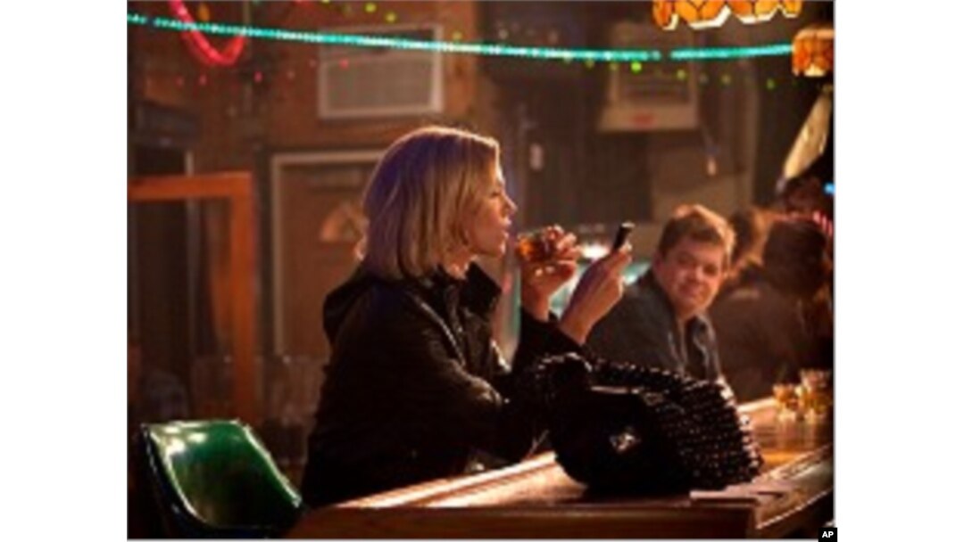 Left to right: Charlize Theron plays Mavis Gary and Patton Oswalt plays Matt Freehauf in YOUNG ADULT, from Paramount Pictures and Mandate Pictures.