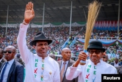 Nigeria's President Muhammadu Buhari, at right, greets supporters during a campaign rally in Rivers State on Feb. 12, 2019. He seeks a second term in the election Saturday.