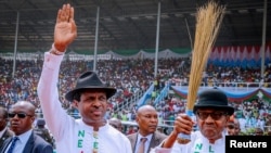 Nigeria's President Muhammadu Buhari greets his supporters during a campaign rally ahead of the country's presidential election in Rivers State, Nigeria, Feb. 12, 2019.