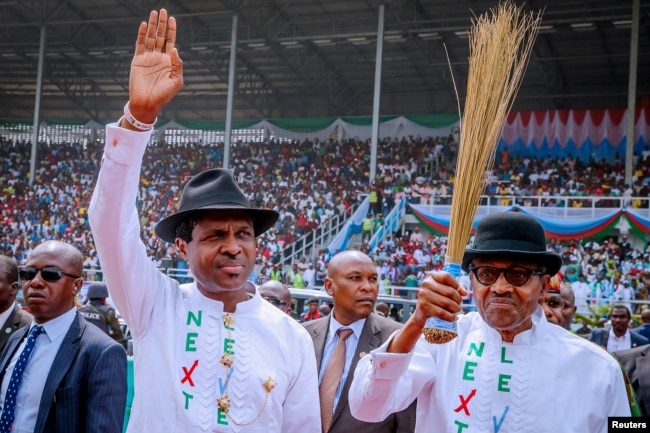 Nigeria's President Muhammadu Buhari, at right, greets supporters during a campaign rally in Rivers State on Feb. 12, 2019. He seeks a second term in the election Saturday.