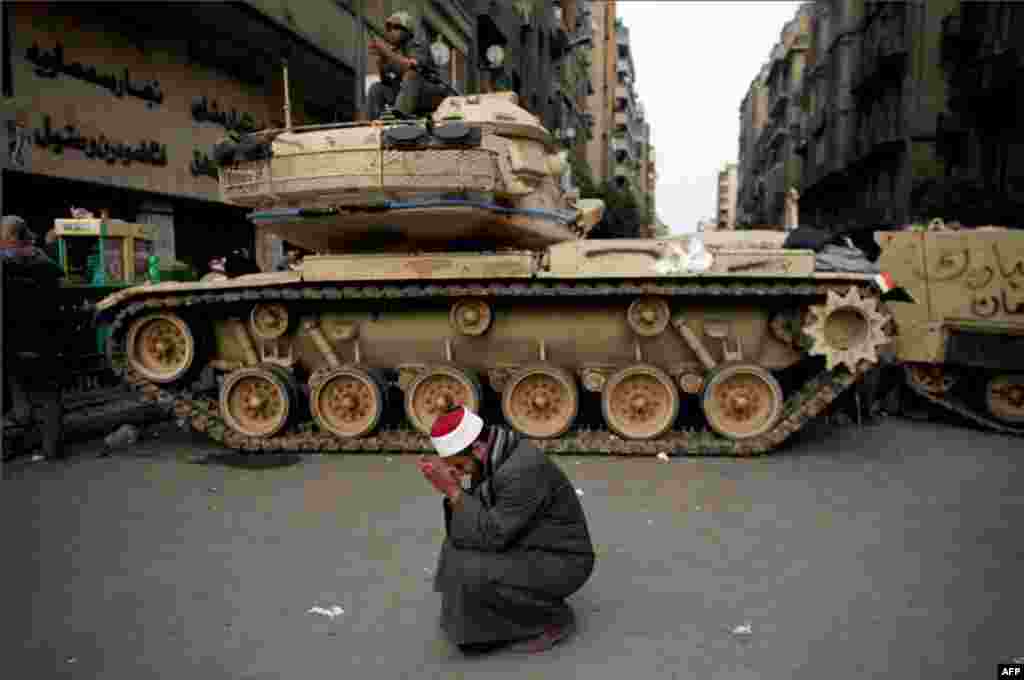 February 2: An egyptian cries in front of an army tank in Tahrir Square. (Tara Todras-Whitehill/AP)