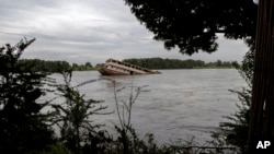FILE - An abandoned boat is seen in the White Nile in Juba, South Sudan, Friday, Oct. 1, 2021. The River Nile reached its highest in a century in 2020, and in some parts of the country the floods have not gone down since then. 