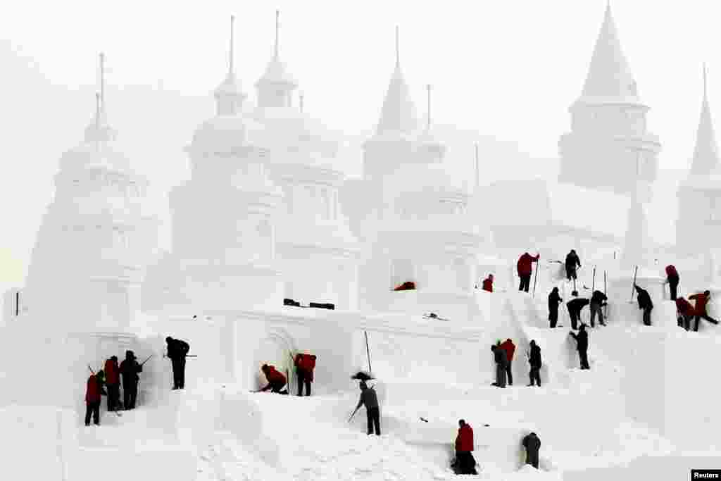 Craftsmen make a snow castle at a park in Changchun, Jilin province, China.
