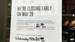 This May 27, 2018 photo shows a sign displayed at a Starbucks cafe in Portland, Maine, reminding customers that the store will be closed Tuesday for training.